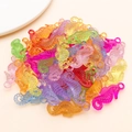 Close-up of colorful translucent seahorse-shaped acrylic pendants for DIY jewelry making - 32x13mm