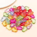 Macro detail of transparent colorful acrylic heart pendants for DIY jewelry making - 15x20mm