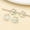 Detailed view of light green translucent star-shaped glass beads with center holes for DIY - Transparent Blue