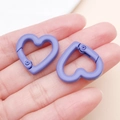 Matte purple heart-shaped spring clasp for DIY accessories shown in hand for scale - Purple
