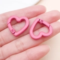 Pink heart-shaped spring clasp for DIY keychains and bags held in hand for scale - Rose Red