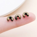 Macro view of small brass crescent crimp covers held on fingertip for DIY jewelry making - Large Antique Bronze (25600)