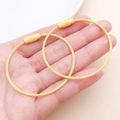 Two yellow stainless steel wire keychains with non-slip screw lock on a hand - Light Yellow