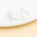 Macro shot of iridescent glass butterfly beads with detailed wing texture for DIY jewelry - Transparent White AB Color