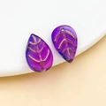 Macro view of handmade purple leaf charms with golden edges for jewelry making - Transparent Blue Purple Gradient Gold Veined (26683)