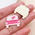 Macro shot of pink enamel car charm with heart detail and golden textured back - Enamel Heart Taxi (27209)