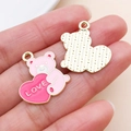 Detail of pink enamel bear love heart pendant with gold-plated texture and LOVE engraving - LOVE Heart Bear (27200)
