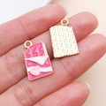 Macro view of pink chocolate charms with heart detail and golden textured back - Enamel Heart Chocolate (27203)