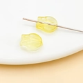 Close-up of translucent warm yellow tulip-shaped DIY glass beads with a pre-drilled hole - Transparent Yellow Tulip (26706)