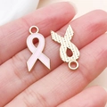 Detailed macro of pink ribbon charms with gold-plated alloy and smooth enamel finish - Pink Enamel Alloy Ribbon Bow Style (24871)