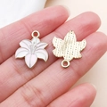 Macro detail of pink gradient lily flower pendants with golden back texture and loop - Pink Two-Tone Enamel Lily Flower Style (24828)