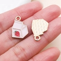 Detail of pink strawberry milk box charms with golden alloy base and enamel finish - Pink Enamel Alloy Strawberry Milk Box Style (24700)