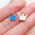 Close-up of crown-shaped alloy pendants in blue and rose gold for DIY jewelry - Crown Style (10995)