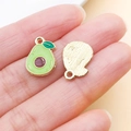 Detail showing the front and back of an avocado enamel charm with golden metal finish - Avocado Fruit Charm (24424)