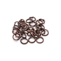 Macro shot of antique bronze jump rings for DIY jewelry making on white background - 4x0.7mm / Antique Red Copper