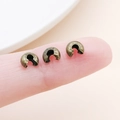 Antique bronze crimp bead covers for jewelry making shown next to finger for scale - Medium Antique Bronze (25593)