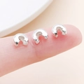 Polished silver C-shaped bead covers for jewelry making held between fingers for scale - Large Bright Silver (25596)