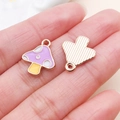 Handheld view of a purple mushroom enamel alloy pendant for DIY jewelry making - Mushroom Style (14976)