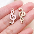 Pink enamel and gold treble clef charms for DIY necklace making held in hand - Pink Alloy Enamel Treble Clef Style (19454)