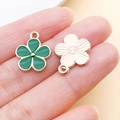 Green enamel flower pendant with gold trim shown on fingertip for DIY jewelry making - Green Flower Pendant (17538)