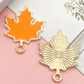 Orange maple leaf enamel pendant with gold trim and textured metal finish for DIY jewelry - Orange