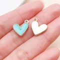 Sky blue enamel and gold heart charms shown on a fingertip for jewelry DIY - Heart Shape Style (14983)