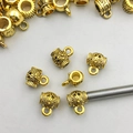 Detailed macro of golden vintage flower engraved pendant charms for DIY jewelry making - Antique Gold Zinc Alloy 3-Way Connectors 8×10mm (14021)