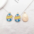 Macro view of geometric enamel easter egg charms with golden radial texture on back - Blue and Yellow Egg