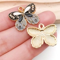 Macro detail of enamel butterfly charm showing front textures and polished gold alloy back - Enamel Black Flower Butterfly (19024)