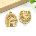 Macro detail of golden horseshoe and horse head charms with polished metal finish - Gold Stainless Steel Large Horse Head Pendant (T2790)