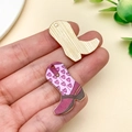 Detail of pink Western cowboy boot pendant with heart pattern held in palm for scale - Gold Purple Heart Cowboy Boot (23776)