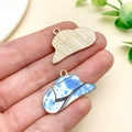 Close-up of alloy cowboy hat pendant with blue marble enamel finish and golden back - Gold Blue Print Cowboy Hat (23764)