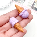 Close-up of resin ice cream cone pendants with purple scoops and metal hanging loops - Purple (23824)