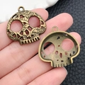 Vintage bronze skull charms with ornate scrollwork held for Gothic jewelry DIY making - Halloween Skull (3185) / 27x27
