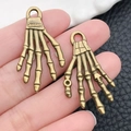 Pair of vintage bronze skeleton hand bone pendants with engraved Fashion text detail - Halloween Skeleton Hand (5712) / 20x35