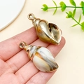 Macro detail of acrylic sea shell pendants with electroplated finish for DIY crafts - Laser Plated Gold Beige Ocean Conch (23619)