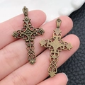 Antique bronze cross charm with intricate filigree details and woven texture shown in hand - Vintage Cross (3566) / 25x38