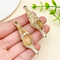 Handheld view of long spiral conch charm with gold accents and hanging metal ring - Laser Plated Gold Beige Ocean Conch (23612)