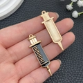 Macro view of gold alloy syringe pendants with black enamel drip detail for DIY keychains - Large Black Syringe (23230)