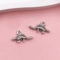 Detailed close-up of two vintage silver stegosaurus charms for DIY jewelry making - Antique Silver Stegosaurus (15765)