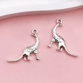 Macro detail of two antique silver dinosaur pendants with textured alloy surface for DIY - Antique Silver Animal Dinosaur (11259)