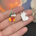 Detail of enamel Christmas stocking pendant with holly leaf design and textured silver back - Yellow Christmas Sock (19676) 22x10mm