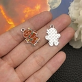 Detailed view showing both sides of a gingerbread man enamel charm for DIY jewelry - Brown Gingerbread Man (19670) 23x17mm
