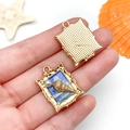 Vue macro d'un pendentif océan doré avec coquillage, perle et relief ciel bleu - 26x19x5mm / Conchiglia Perle Carrée Océan / Émail Bleu (23582)