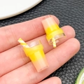 Macro shot of miniature resin milkshake charms with orange gradient and striped straws - Yellow (24294)