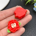 Detail of resin camellia flower pendant with green leaves and metal loop for DIY crafts - Red (24611)