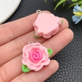 Macro shot of pink resin rose charms with green leaves and silver loops for DIY jewelry - Pink(24609)