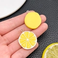 Detailed view of resin lemon slice charm with silver loop for DIY jewelry projects - Orange