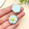 Detailed view of blue resin daisy pendants with silver rings for DIY jewelry making - Lake Blue (24599) / 1 Piece/Pack (25x21x8mm)