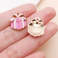 Detailed close-up showing pink and white enamel gift box charm with golden plated texture - Pink Christmas Gift Box Style (24817)
